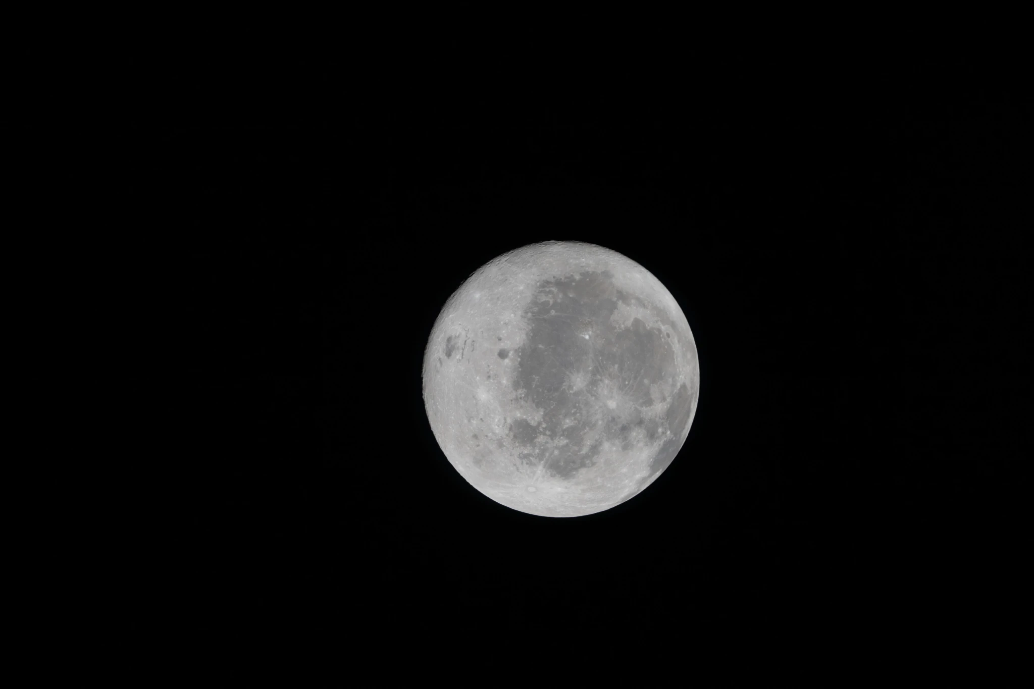 A view of the nearside of the Moon, the side we always see from Earth. Some of the far side is visible, as well, on the left edge, just beyond the black patch that is Orientale basin, a nearly 600-mile-wide crater that straddles the Moon’s near and far sides and is partly visible from Earth. The dark areas in the center and right side of the disk are ancient lava flows, which are unique to the near side of the Moon. The white dot at the bottom of the disk, with white rays shooting out from it, is Tycho crater, one of the younger craters on the Moon at 108 million years old.